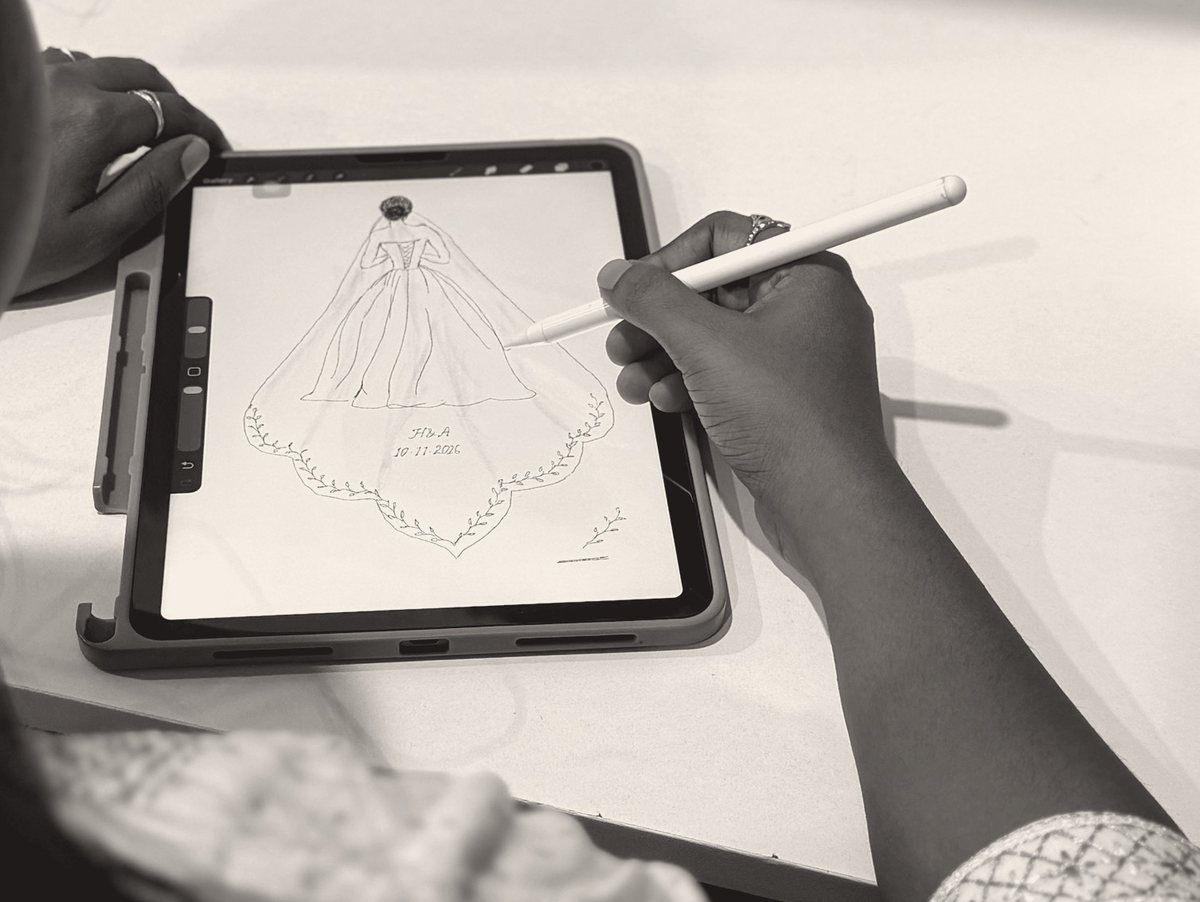 Ruhi sketching a veil design on a tablet